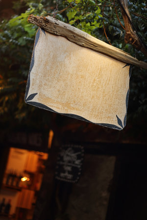 mysterious hanging wooden sign in the twilightの写真素材