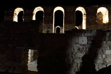 Dramatically illuminated ruins of an ancient temple in Nessebar, Bulgariaの写真素材