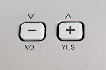 Close up of a button control panel with arrows and the words 'yes' and 'no'.の写真素材