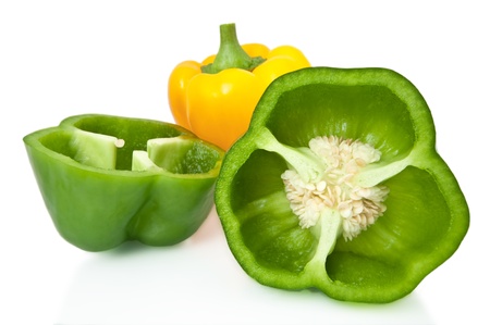 Close and low level capturing a selection of whole and halved bell peppers arranged over white.の写真素材