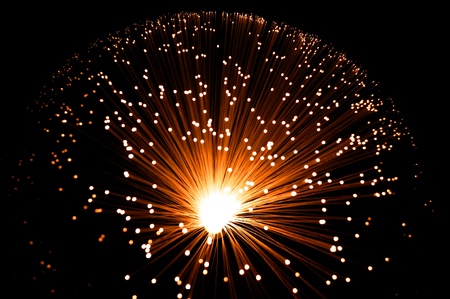 Overhead view capturing a golden illuminated fibre optic lamp against black.の写真素材
