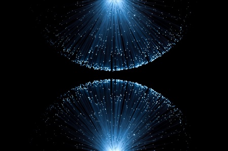 Two groups of illuminated blue fibre optic light strands eminating from the top and bottom border of...