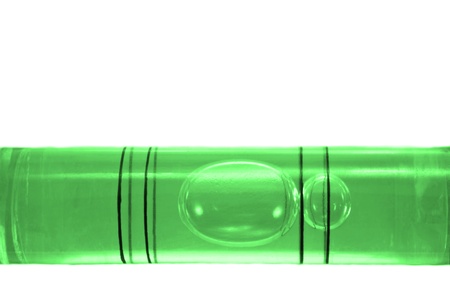 Close up on a the bubble of a green spirit level arranged over whiteの写真素材