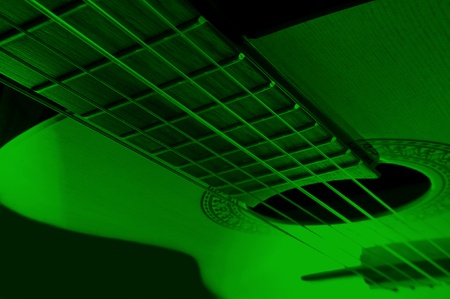 Acoustic guitar with extreme green light effect.の写真素材