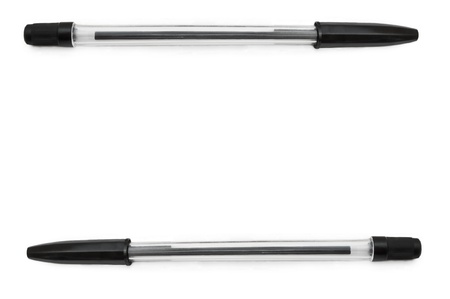 Two black pens arranged at the top and bottom border of the image and over whiteの写真素材