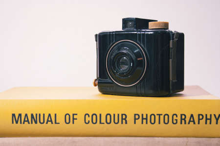 A vintage Kodak Baby Brownie Special sat on a yellow photography manual.のeditorial素材