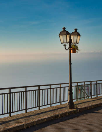lantern and railing over the amalfi coast in italyの写真素材