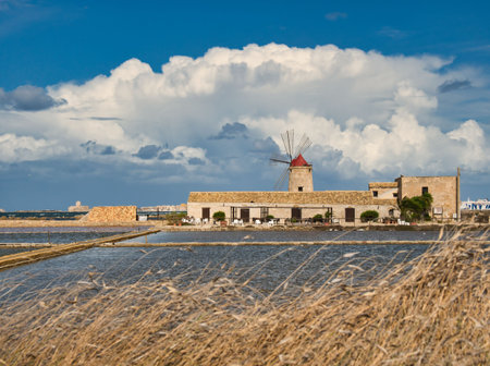 windmills in the salt flats of trapani in sicily. Salt production is based on the principle of natural evaporation.の写真素材