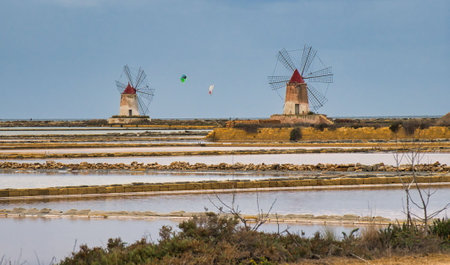 windmills in the salt flats of trapani in sicily. Salt production is based on the principle of natural evaporation.の写真素材