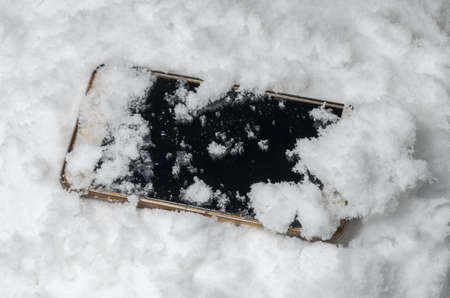 Lost cell phone is in the snowの写真素材