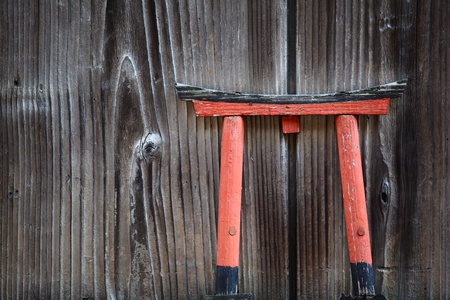 Miniature Torii gate ornament at an exterior wallの写真素材