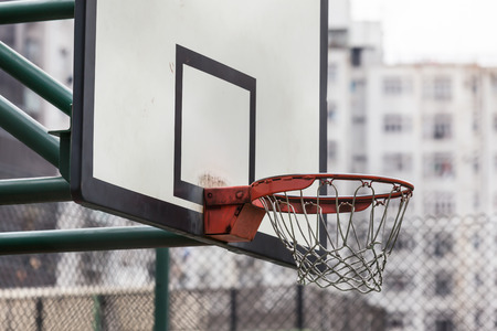 Basketball backboard at a sports ground near a housing area