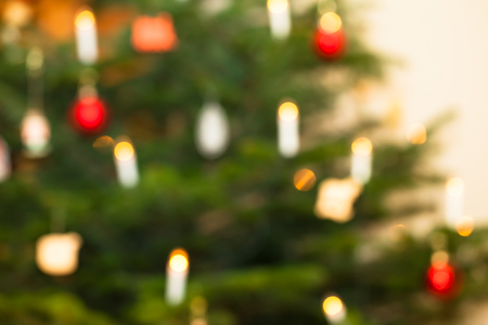 Defocused background of christmas tree with illuminated candlesの写真素材