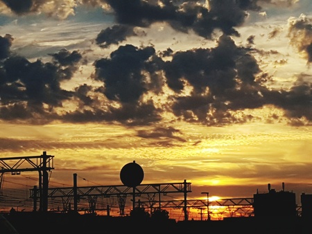 sunset with yellow, orange cloudsの写真素材