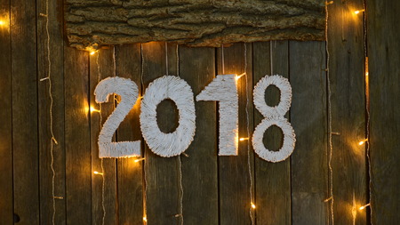 New year 2018. Image numbers in 2018 in the background are made of wood with glowing harlandale zolotym or yellow warm colorの写真素材