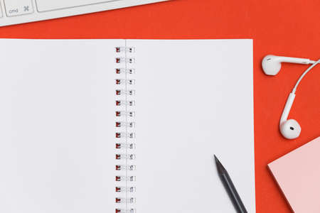 Creative flat lay photo of workspace desk with copy space. Top view office desk with notepad, red...