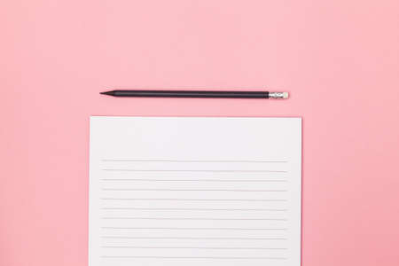 Blank page in a line with black pencil. Plans and goals for the year. Freelancer workplace concept. Top view with copy space for input the text. Flat lay, colored pink background. Mockupの写真素材