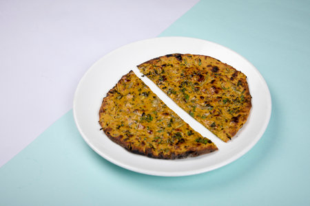 Turkish Omelette on a white plate on a blue and green backgroundの写真素材