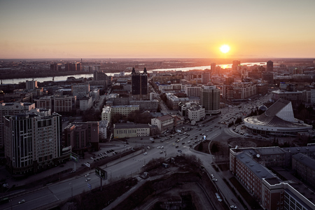 aerial shot of the Siberian capital Novosibirsk city at sunset in early cold springの写真素材