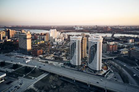aerial shot of the Siberian capital Novosibirsk city at sunset in early cold springの写真素材