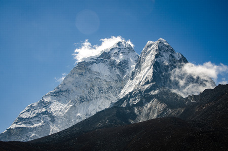 beautiful view of Ama Dablam from trek to Everset and a clouds in a sunny day near the summit.の写真素材
