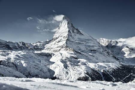 great view of Matterhorn East face in a bright winter day with a good weather with a little bit clouds nearbyの写真素材