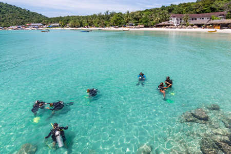 A group of Scuba Diving students have a lesson in the shallow crystal clear water of a Tropical Island.の写真素材