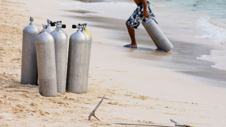 A collection of scuba divers air taks on a tropical white sand beach.の写真素材