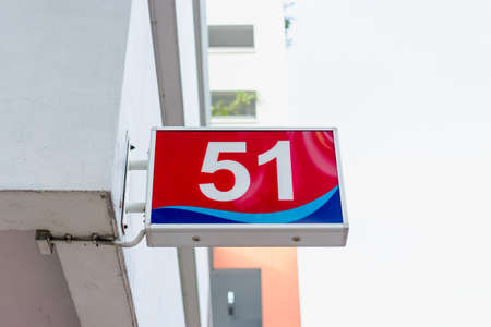 Number 51 sign hung on side of a building.の写真素材