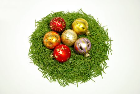 Christmas balls in nest of pine tree needles ,isolated on whiteの写真素材