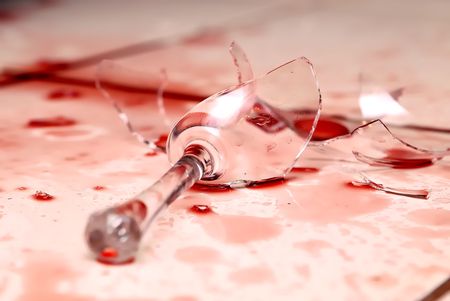 Shattered Glass of wine over white ceramic tileの写真素材