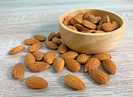 almond on wooden table with spoon, Almond in wooden bowl.の写真素材