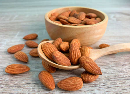 almond on wooden table with spoon, Almond in wooden bowl.の写真素材