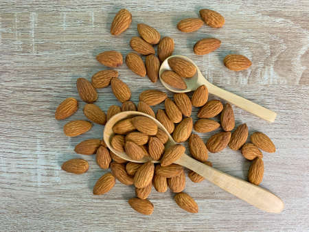 almond on wooden table with spoon, Almond in wooden bowl.の写真素材