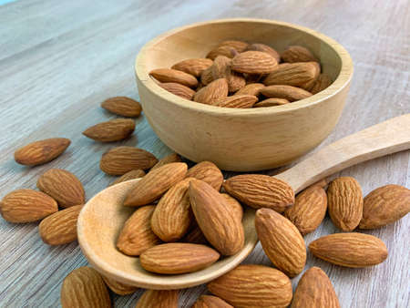 almond on wooden table with spoon, Almond in wooden bowl.の写真素材