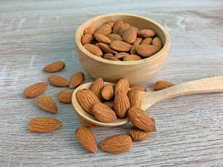 almond on wooden table with spoon, Almond in wooden bowl.の写真素材