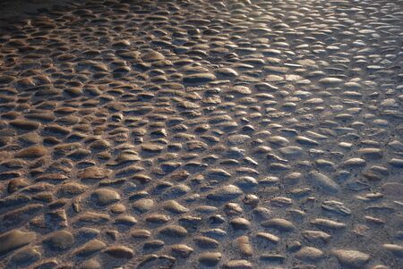 Stoned road at evening with sun goes down, ancient street.の写真素材