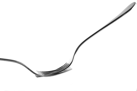 Two silver forks on white balancing
