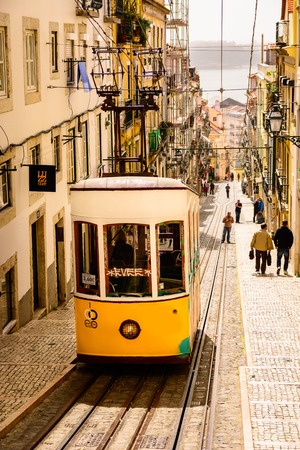 Yellow tram in steep street Lisbon, Portugalのeditorial素材
