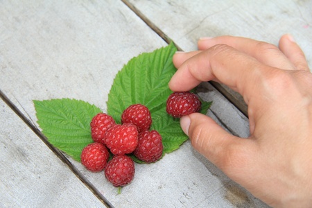 Raspberries on old wooden table