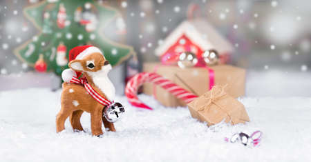 deer in a hat of Santa Claus on the background of New Year's decorationsの写真素材