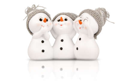 three snowmen isolated on white with reflectionの写真素材