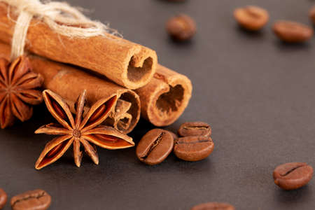 coffee beans, star anise and cinnamon on a black background. close-up