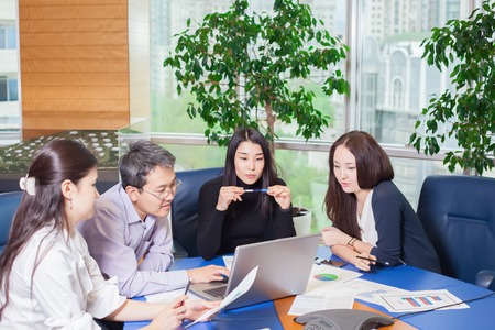 Business meeting, Asian people sitting for table with business plan on high floor in the office. business people negotiateの写真素材