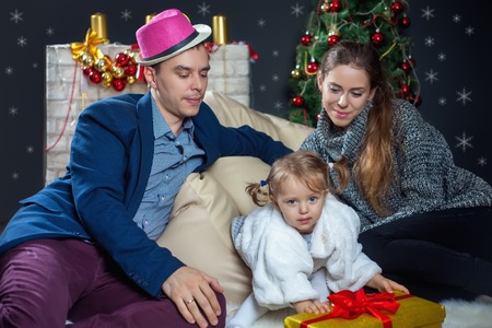 Young family posing on the background of Christmas. In anticipation of Christmasの写真素材