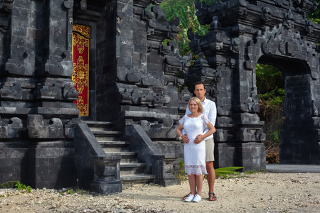Romantic couple on the background of Bali temple. On a Sunny summer dayの写真素材