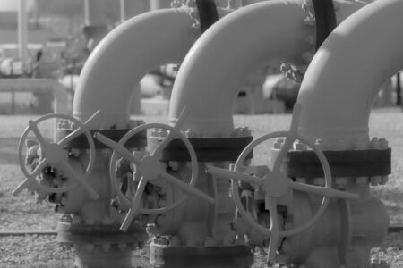 These are old valves on a pipeline. They are still in operation with no leeksの写真素材
