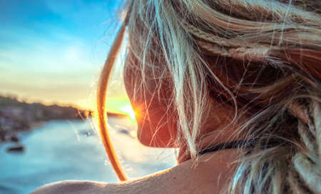 Girl watching sunset indian oceanの写真素材