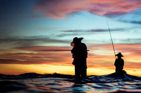 Two fisherman in process fishing.の写真素材