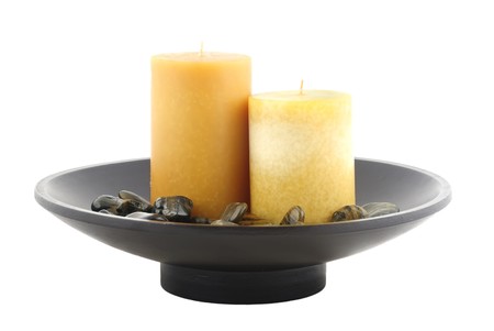Plate with candle and rocks isolatedの写真素材